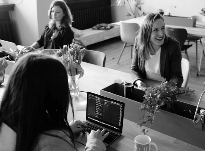 women talkin in office